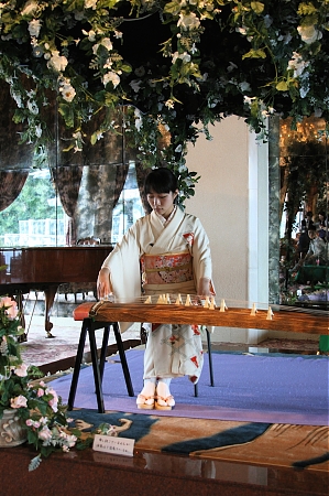 A young woman playing the koto.
