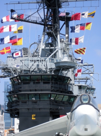 The USS Midway communication tower with color flags.