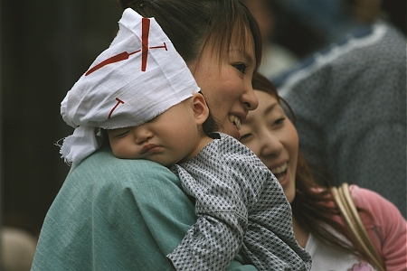 A baby sleeps during the Asukusa Sanja Festival in Tokyo, Japan.