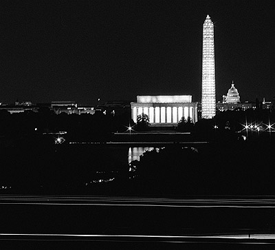 Washington monuments at night as seen from the Iwo Jima memorial park.