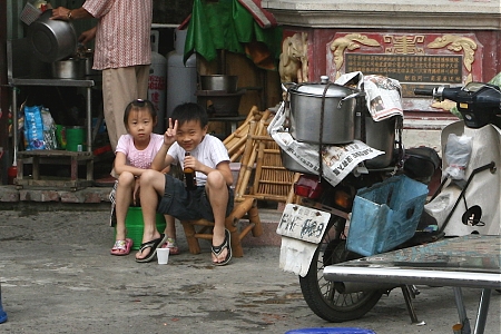Two small children smile for the camera in Jianyuan, Taiwan.