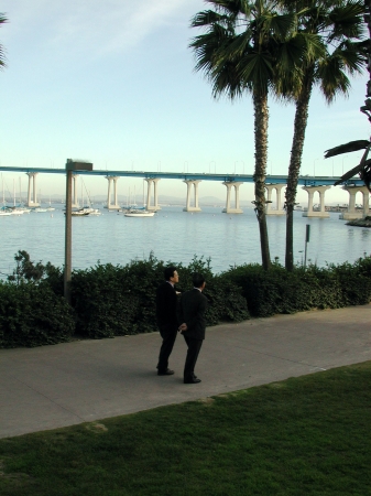 Two men walking in a park on Coronado Island in California.