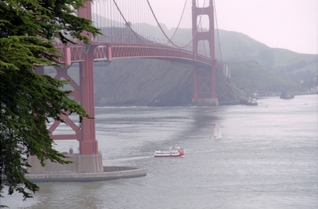 A misty view of the Golden Gate Bridge over the San Francisco Bay.