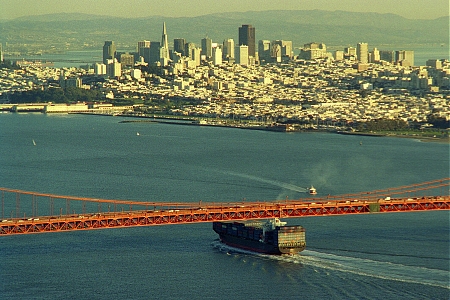A ship narrowly passes under the Golden Gate Bridge in San Francisco Bay.