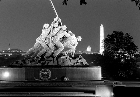 A floodlit view of the Iwo Jima memorial, Washington Monument and United States Capitol in Washington, D.C.