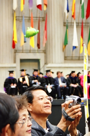 A parent videotaping the college graduation ceremony at UC Berkeley, California.