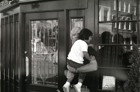 A photograph of a man outside a pub in Georgetown comforting a crying child.