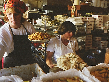 Two ladies making hot apple pies at Mom's Apple Pie Shop in Julian, CA.