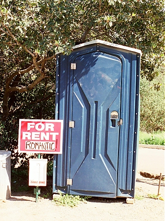 A romantic port-o-potty in the country.