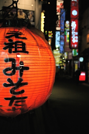 A view of a red lantern on a Japanese street.
