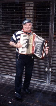 A quintessential Scot playing an accordion.