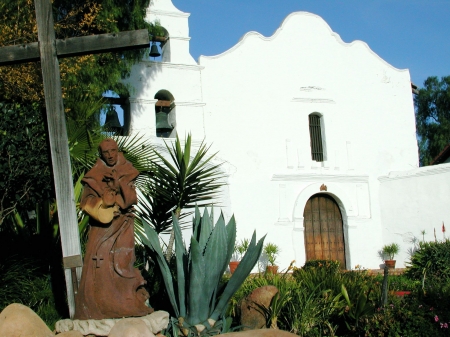 The friar, cross and gardens at the Mission San Diego.