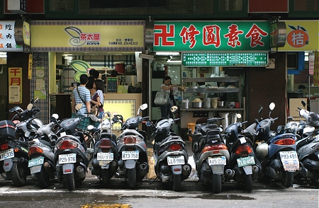 Scooters parked along a street in Taipei, Taiwan.