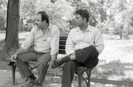Two men talking on a park bench near the National Mall in Washington, D.C.