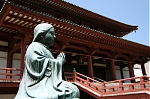 A small buddhist praying statue at the Zojo-ji Temple in Tokyo, Japan.