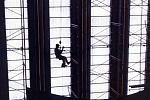 A working dangling from scaffolding inside a building of the U.N. headquarters on the East side of Manhattan (NYC).