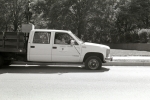 Two guys sitting in the cab of truck with a flat tire on a street in Washington, DC.