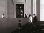 A view of people moving down an escalator into the Washington, D.C. metro subway.